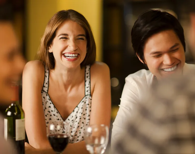 Friends laughing at a restaurant