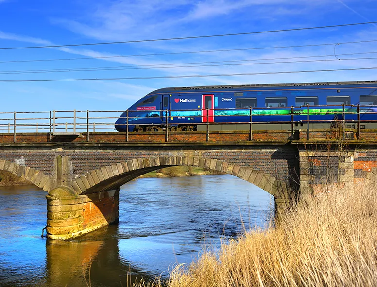 A Hull Trains service passing over a bridge and water