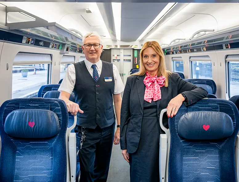 Two Hull Trains onboard crew members standing inside the carriage