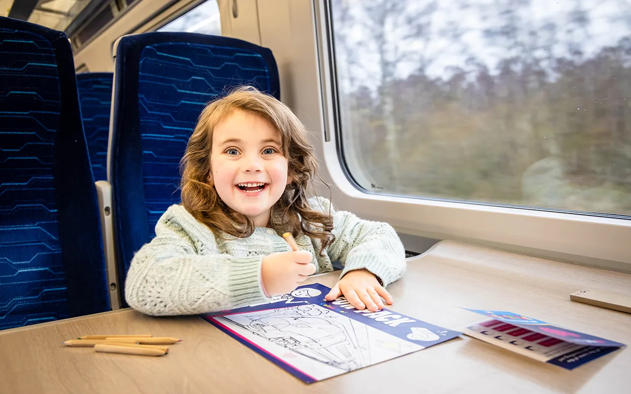 A child travelling onboard a Hull Trains service with a kids activity pack